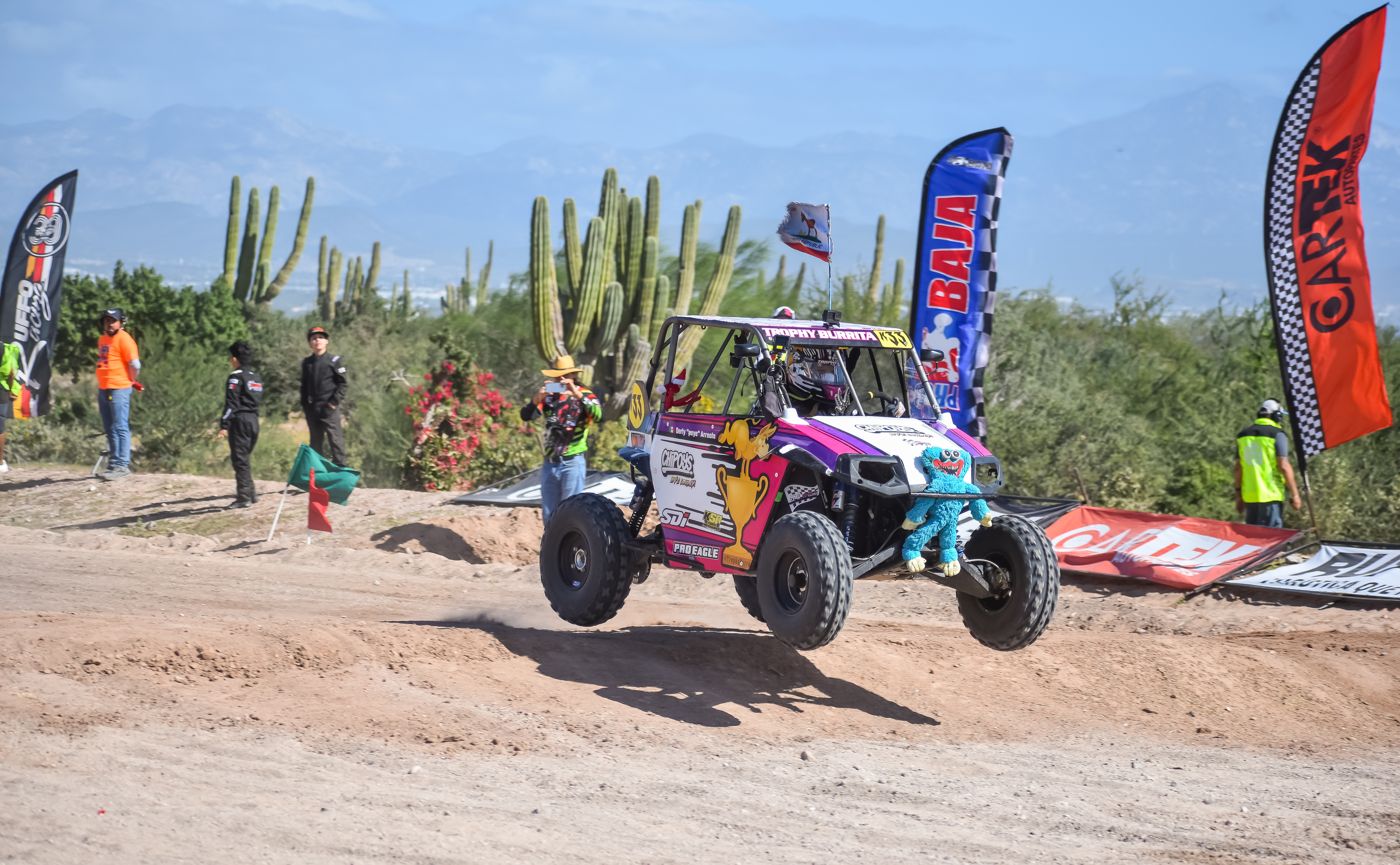 Emma Valentina Flynn getting light over a Baja jump in the Trophy Burrita car.