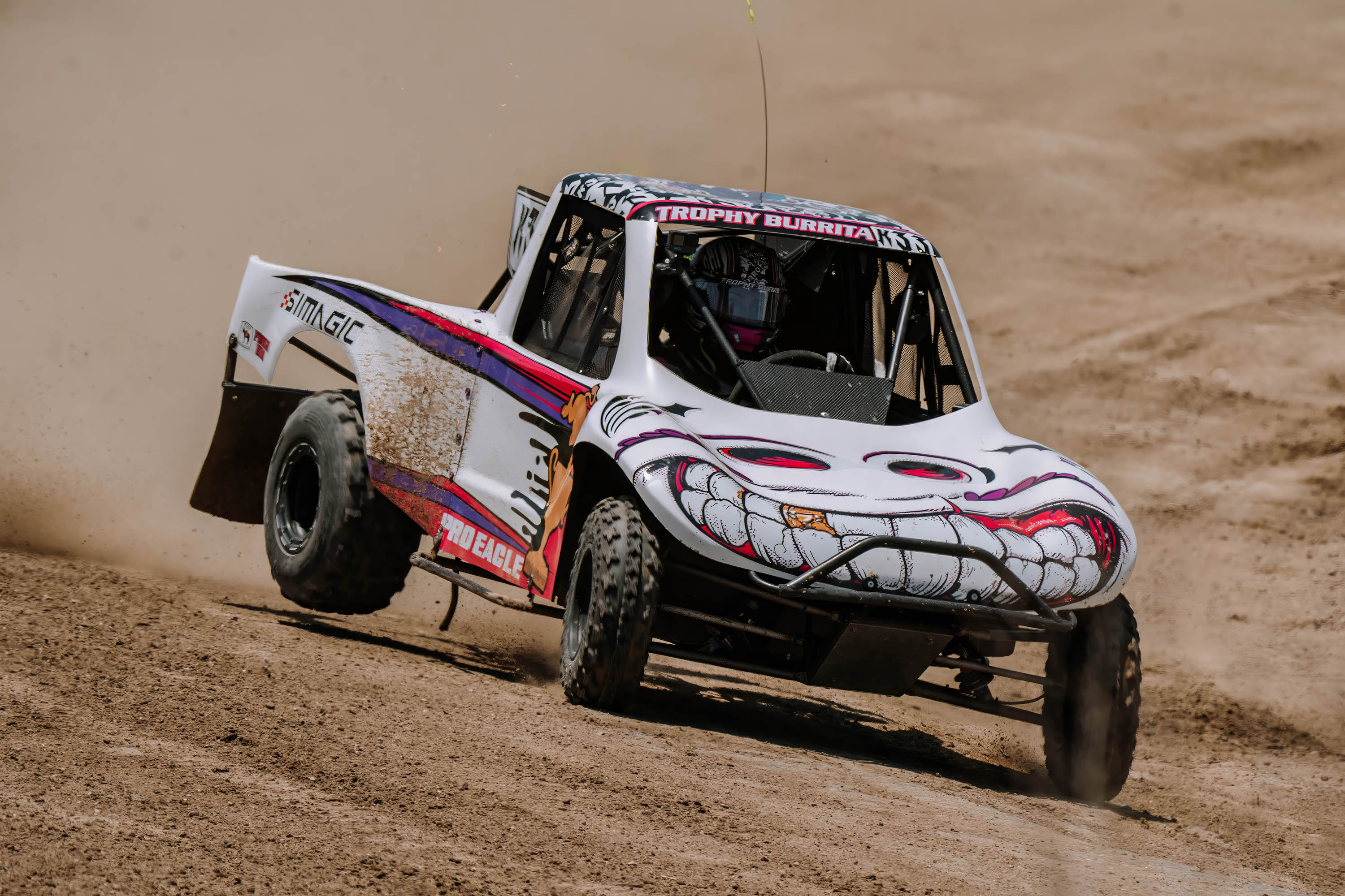 Emma Valentina Flynn pushing the Open 450 Mod Kart through a fast dirt corner.